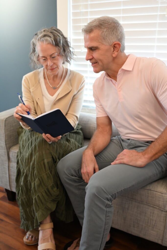 Couple reviews their giving plans together in a notebook