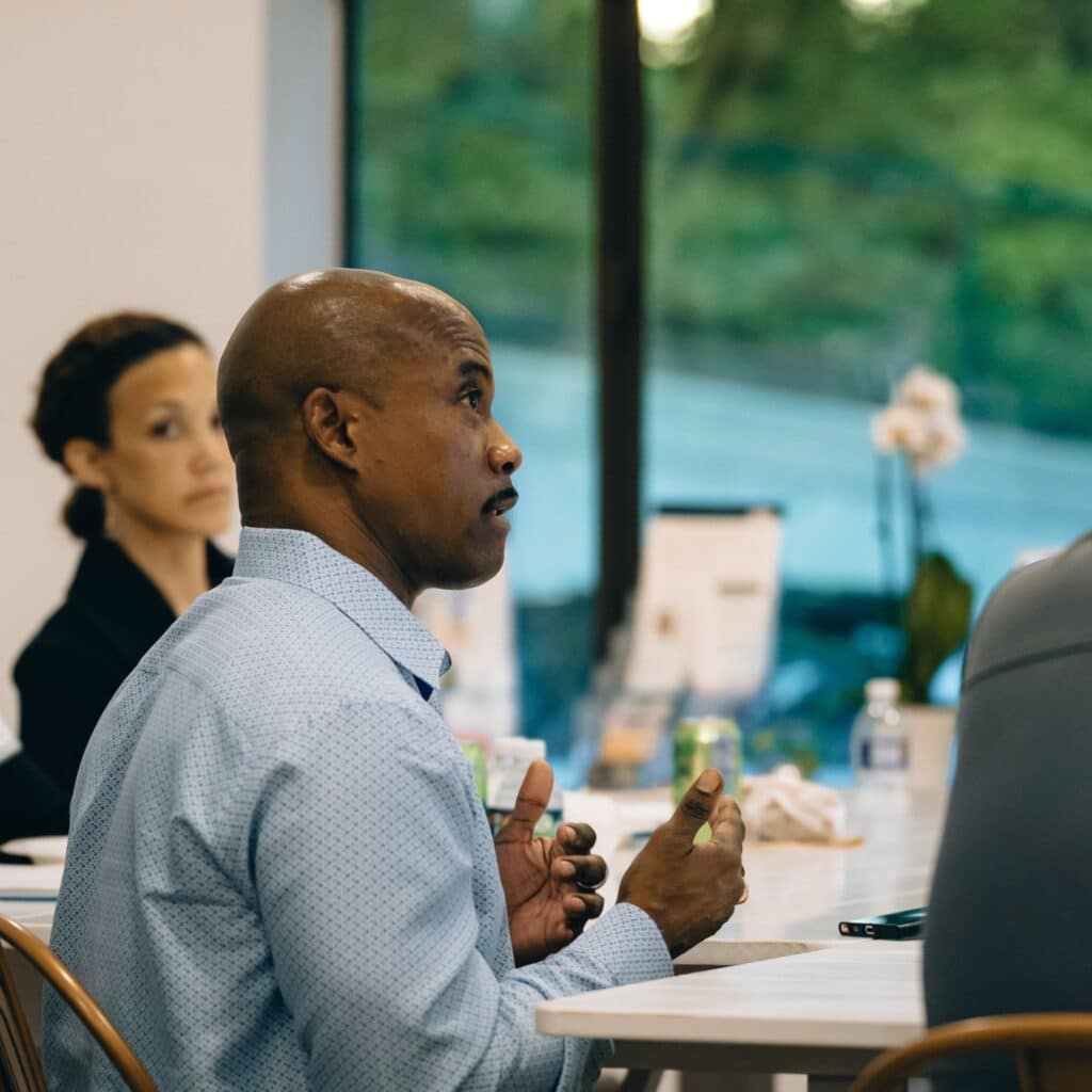 Fellow shares his perspective during a small group discussion at a Severn Leadership Group session