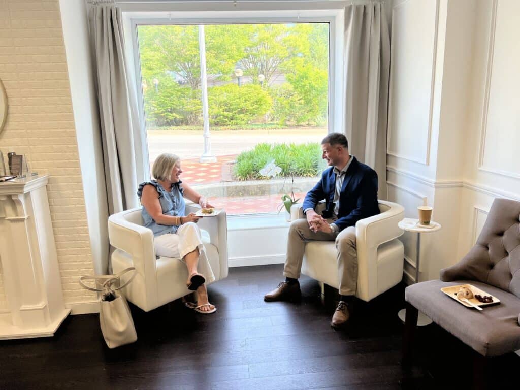 Mentor and Fellow talk one on one in armchairs during a Severn Leadership Group mentoring session